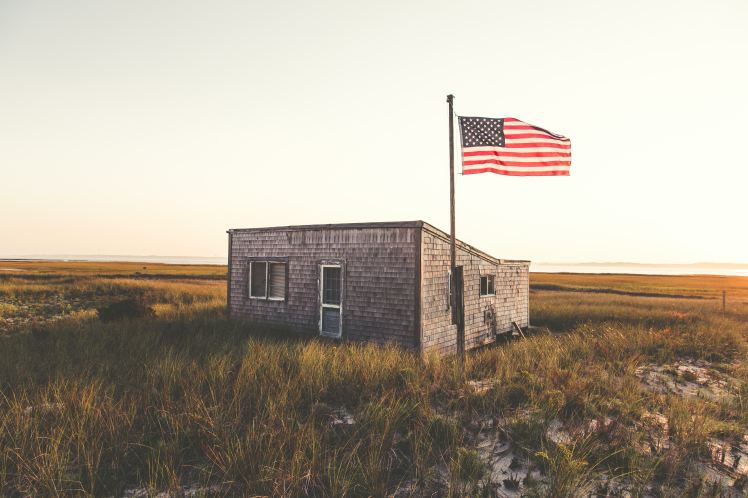 outpost in the middle of grasslands with an American Flag